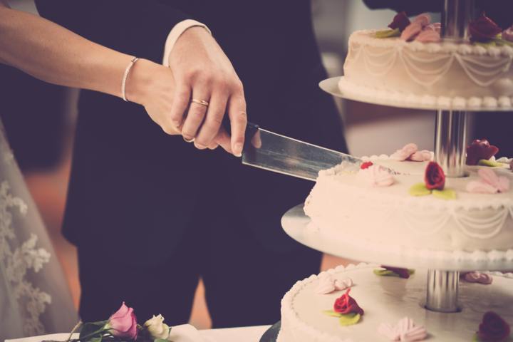 a woman cutting a cake with a knife